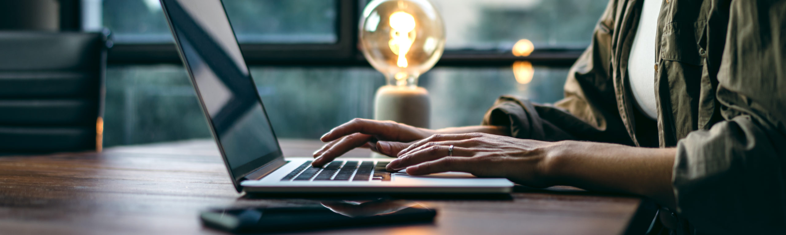 Young woman working with a laptop. Female freelancer connecting
