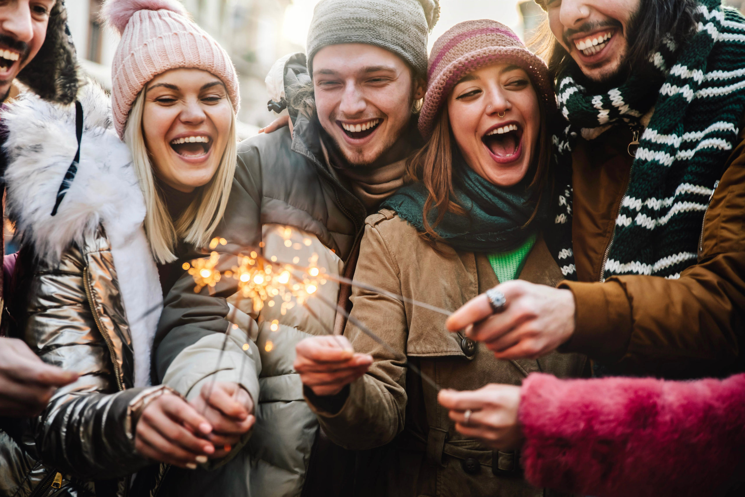 Close up image of happy friends enjoying out with sparklers - Gr