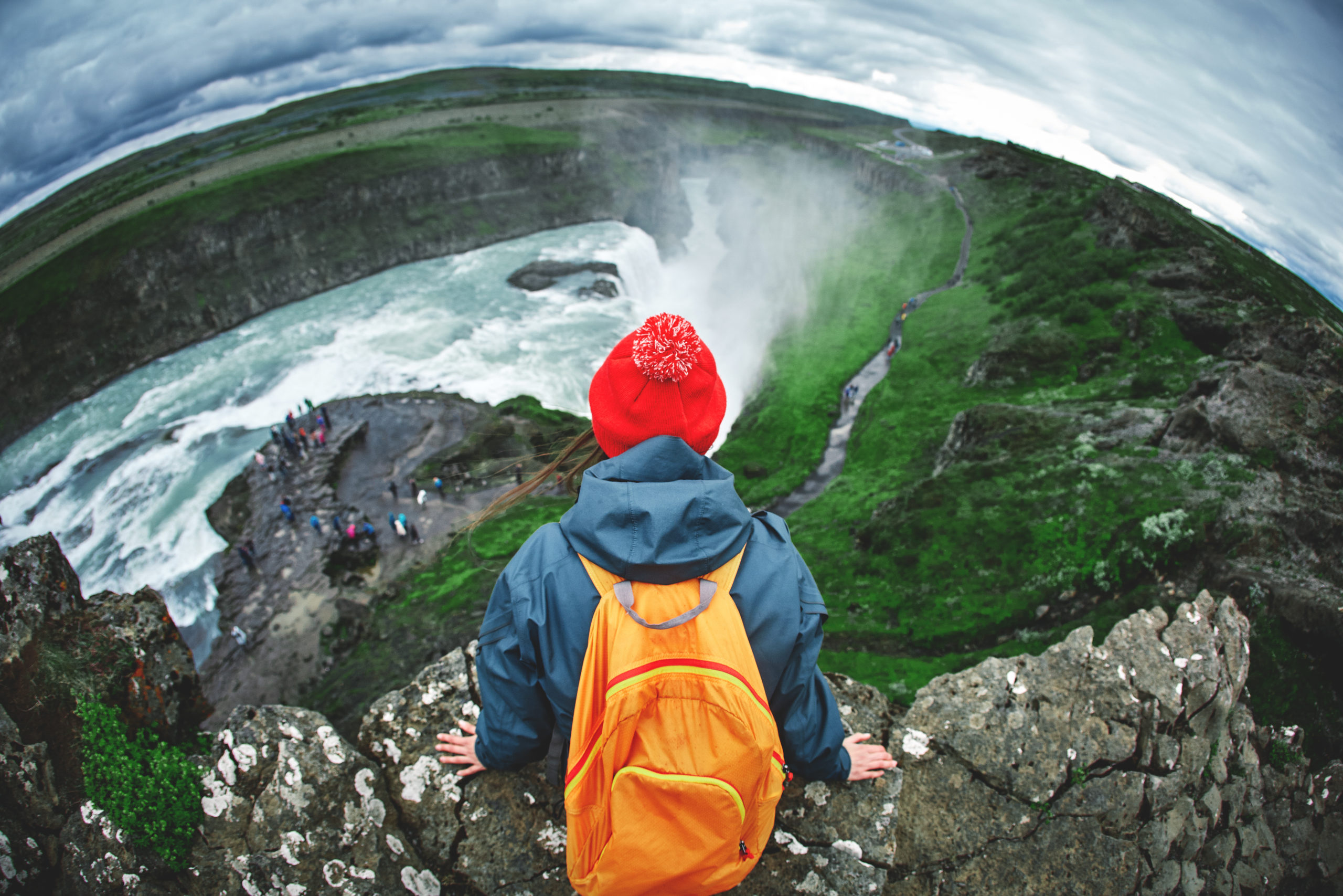 Cheerful woman walking and posing on nature in Iceland